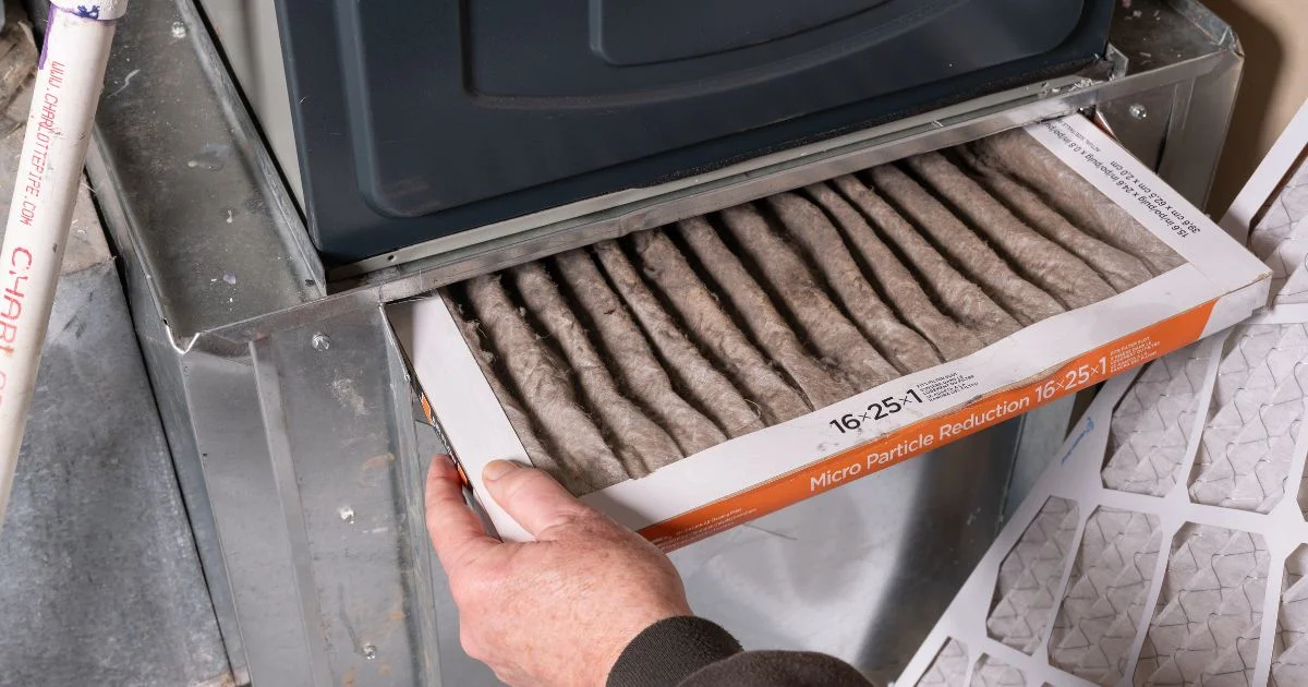 Dirty furnace air filter being removed