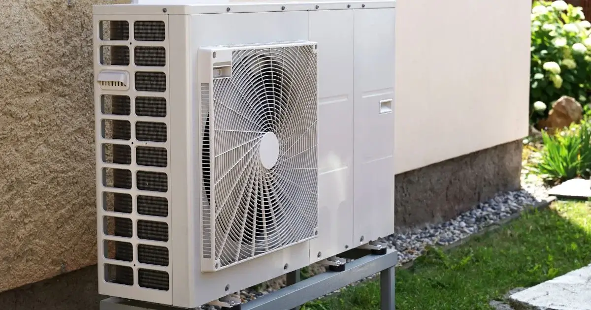 Residential outdoor heat pump installed beside home